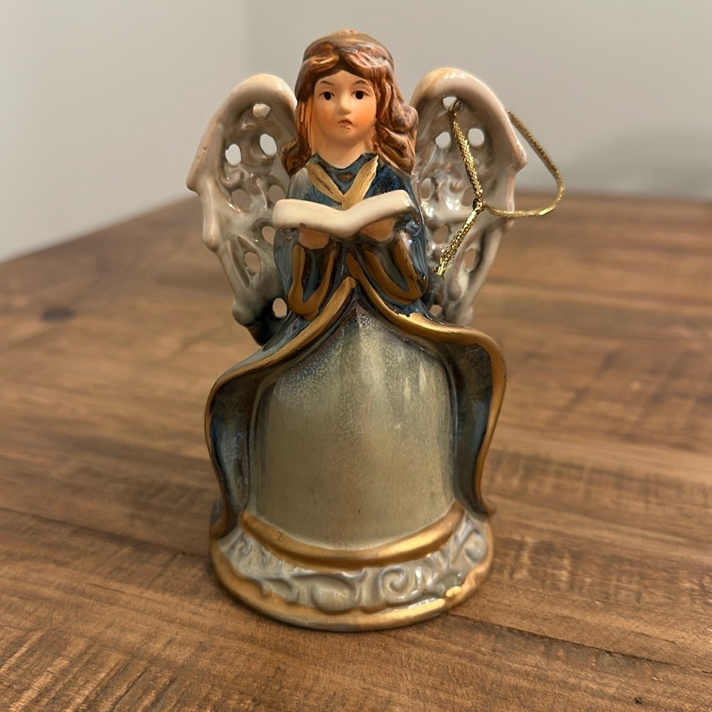 Ceramic Angel Bell. Gold cord attached to the wing, to use as Christmas ornament
